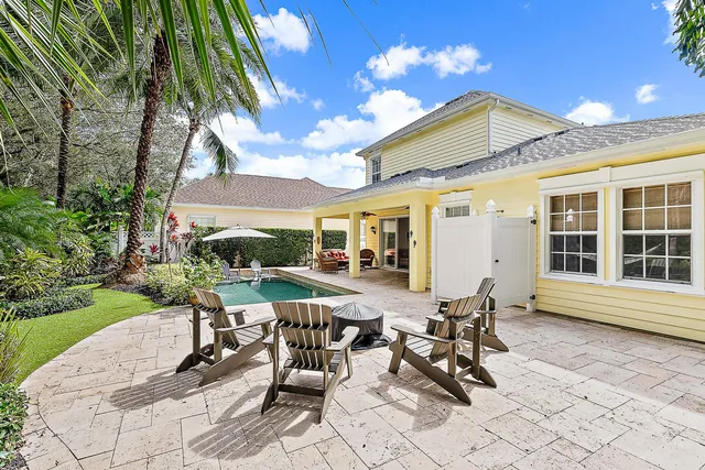 a view of a patio with table and chairs and potted plants