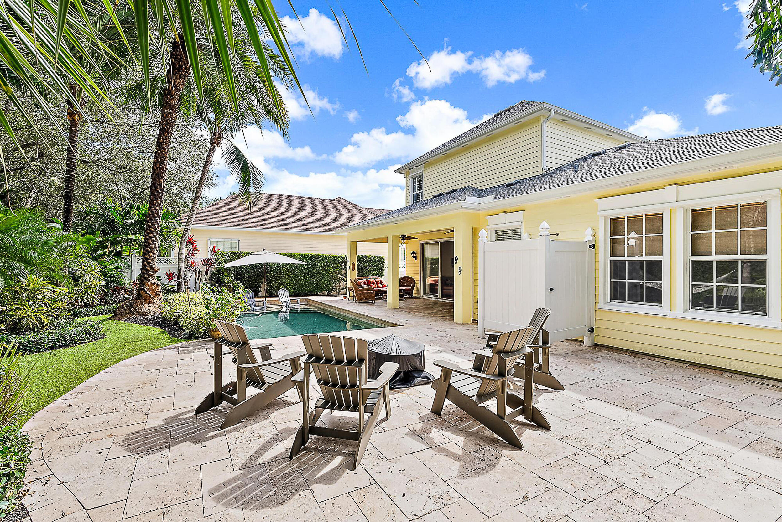 140 Sweet Bay Circle Jupiter, FL 33458 - Photo 5 of 36 a view of a patio with table and chairs and potted plants