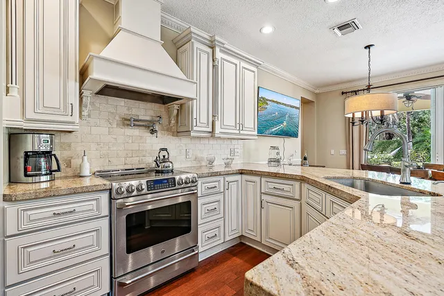 a living room with furniture kitchen view and a wooden floor