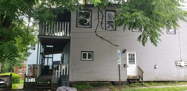 a view of a house with a backyard
