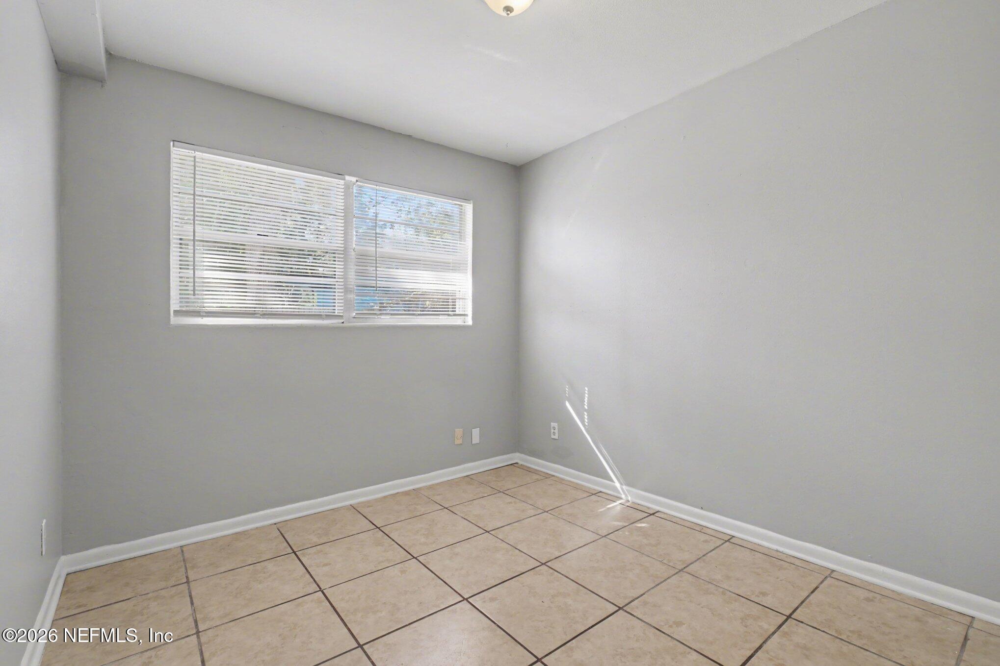 4852 Hatteras Road Jacksonville, FL 32208 - Photo 11 of 15 a view of an empty room with a window