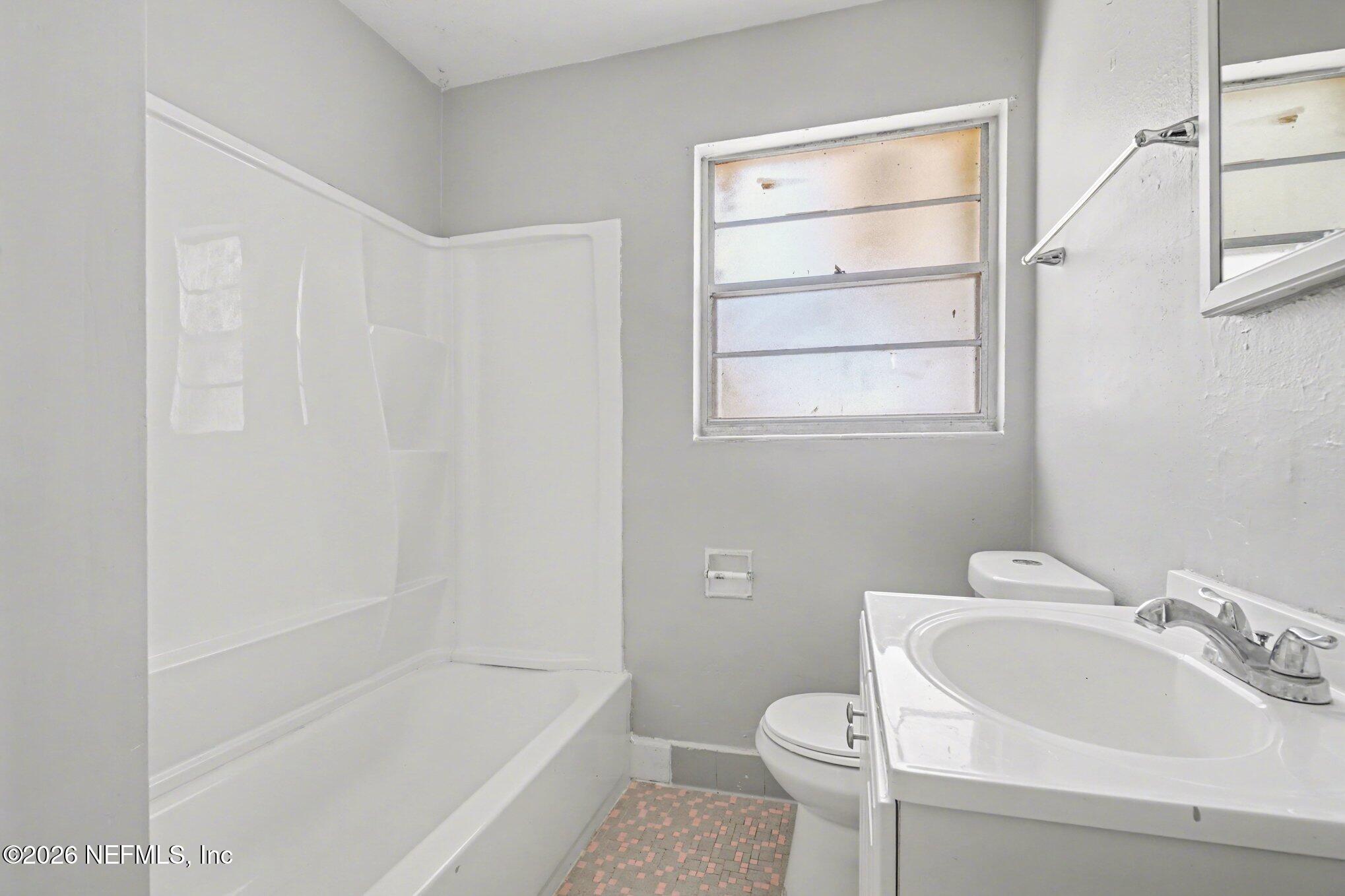 4852 Hatteras Road Jacksonville, FL 32208 - Photo 14 of 15 a bathroom with a sink toilet and bathtub