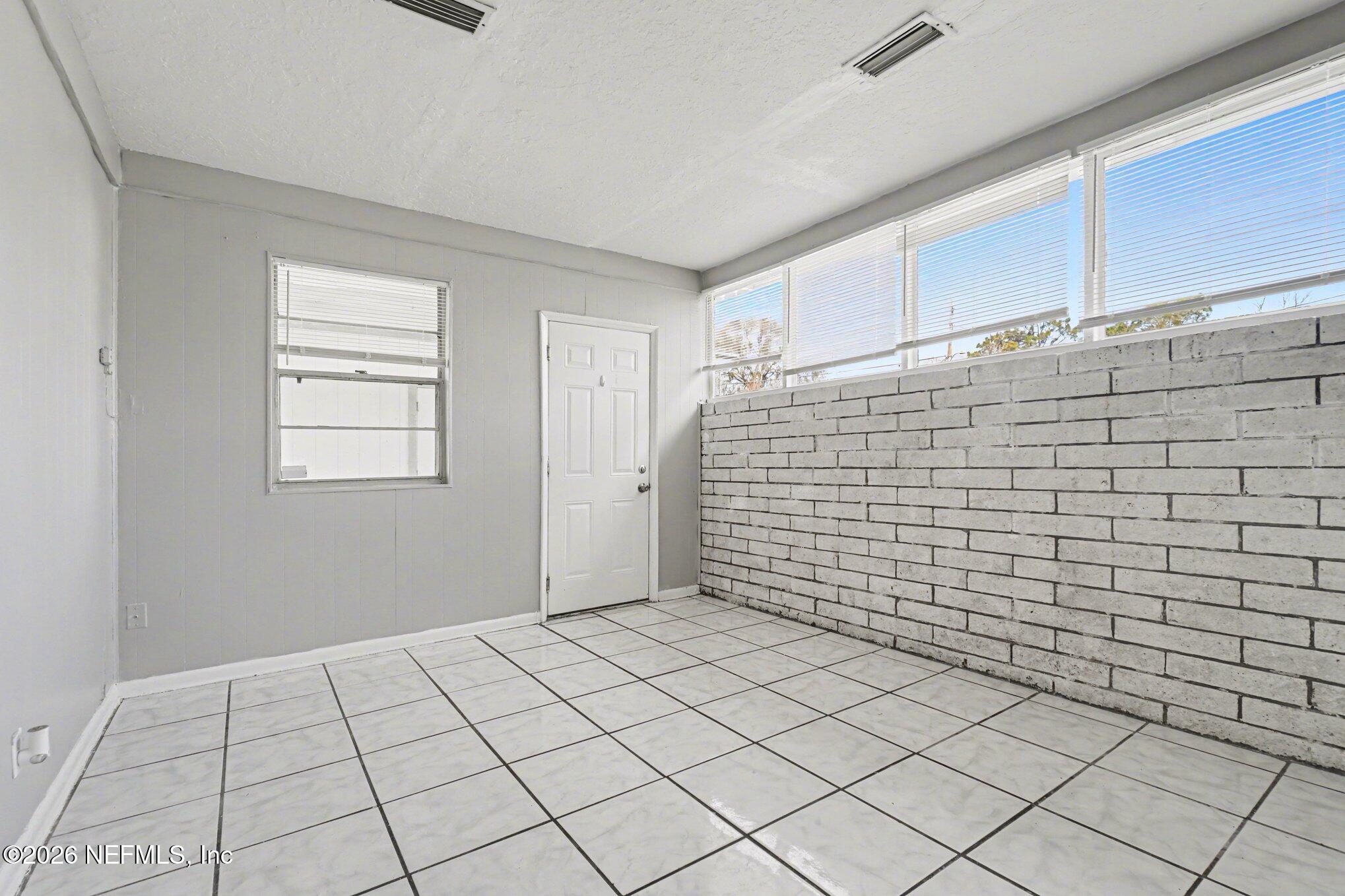 4852 Hatteras Road Jacksonville, FL 32208 - Photo 5 of 15 a view of an empty room and window