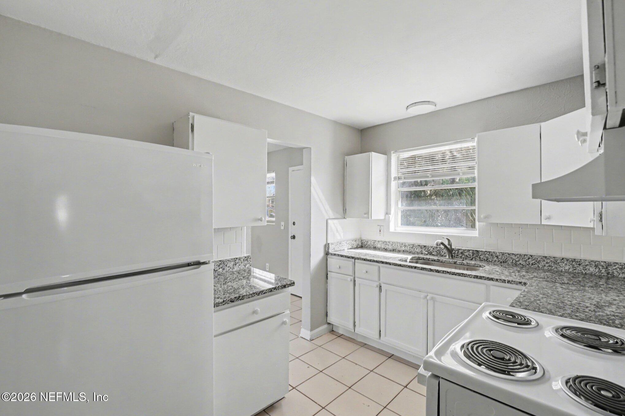 4852 Hatteras Road Jacksonville, FL 32208 - Photo 8 of 15 a kitchen with a sink stove and refrigerator