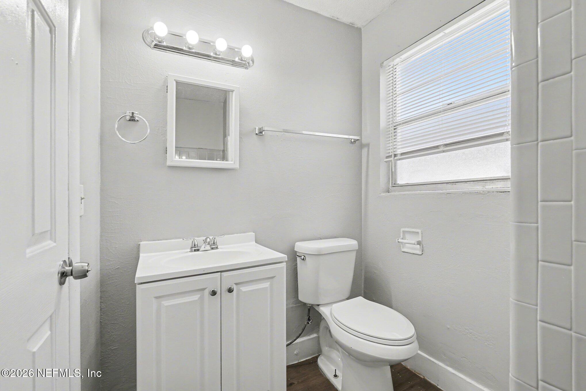 4852 Hatteras Road Jacksonville, FL 32208 - Photo 9 of 15 a white toilet sitting next to a bathroom sink