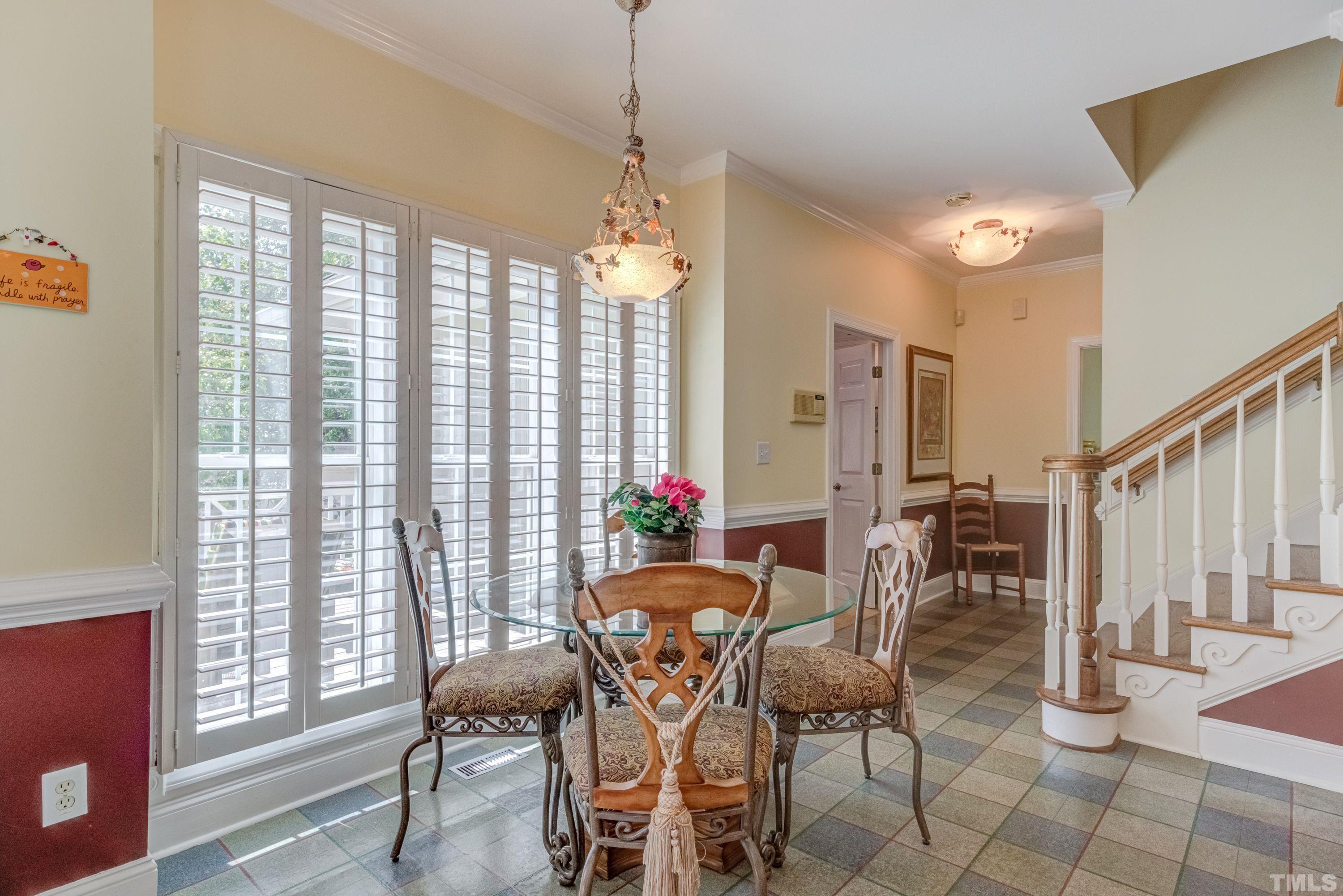 5646 Red Hill Church Road Coats, NC 27521 - Photo 11 of 31 a dining room with furniture potted plants and wooden floor