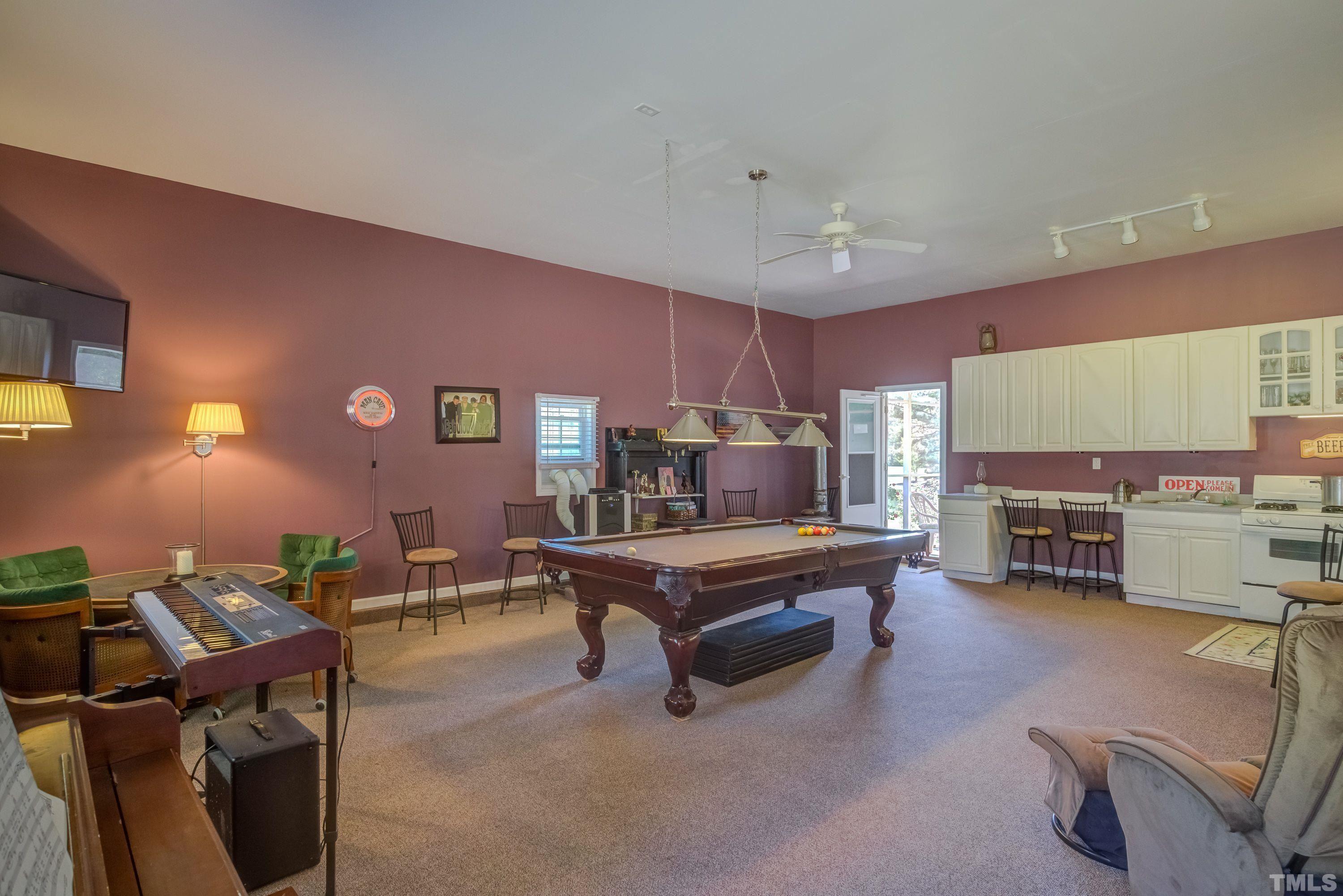 5646 Red Hill Church Road Coats, NC 27521 - Photo 13 of 31 a living room with furniture pool table and a fireplace