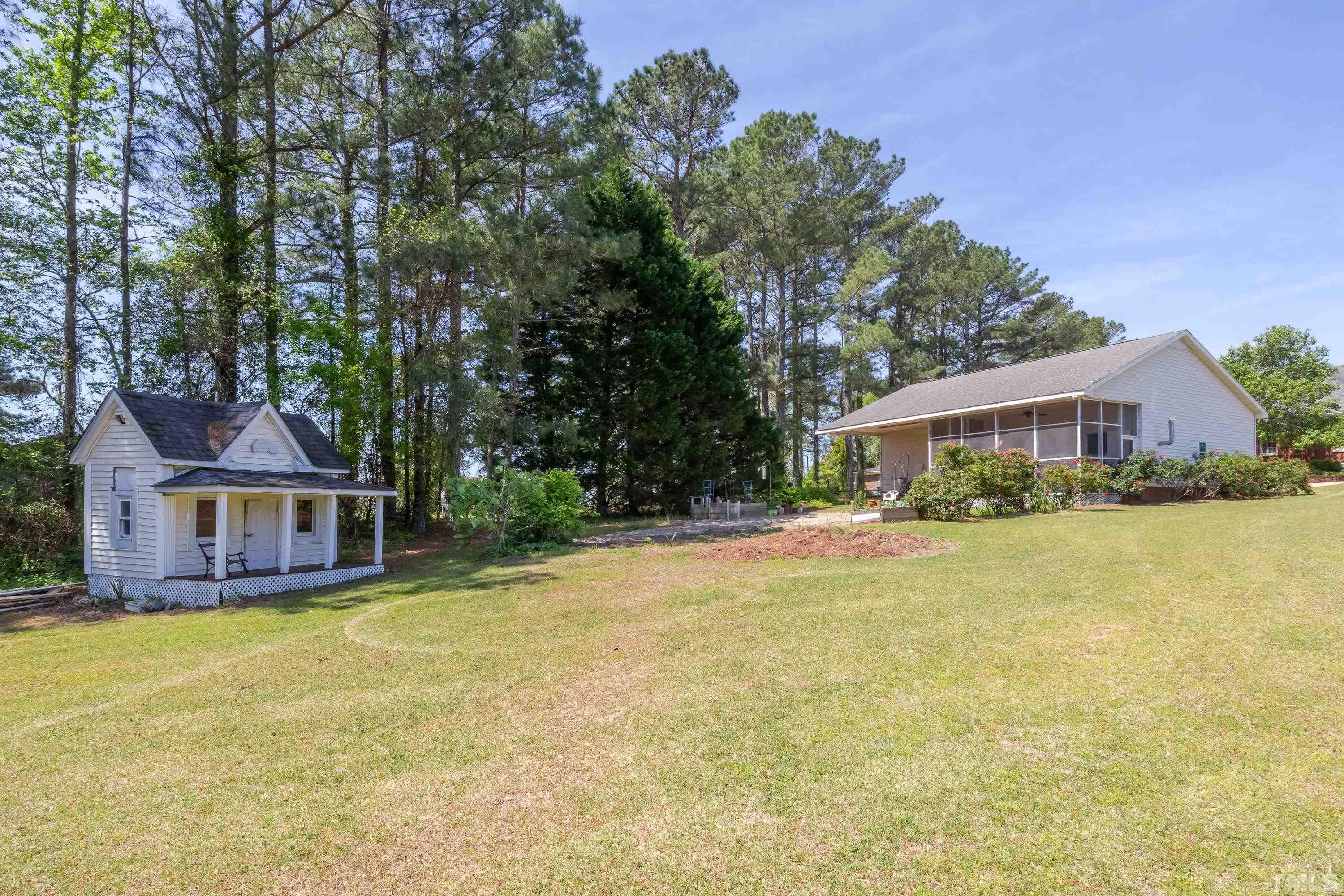 5646 Red Hill Church Road Coats, NC 27521 - Photo 15 of 31 a front view of a house with swimming pool and porch