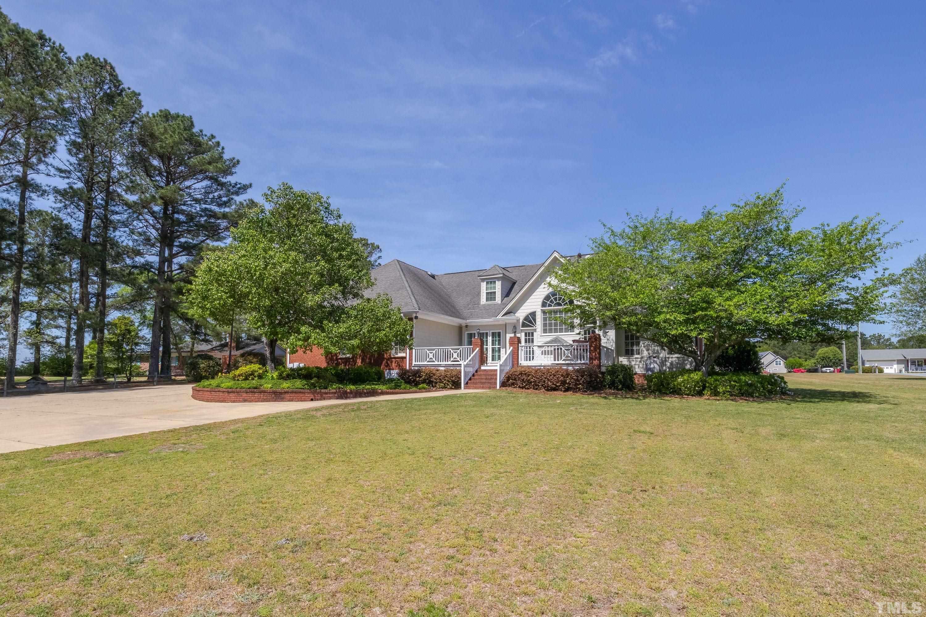 5646 Red Hill Church Road Coats, NC 27521 - Photo 2 of 31 a view of a house with a yard and a tree