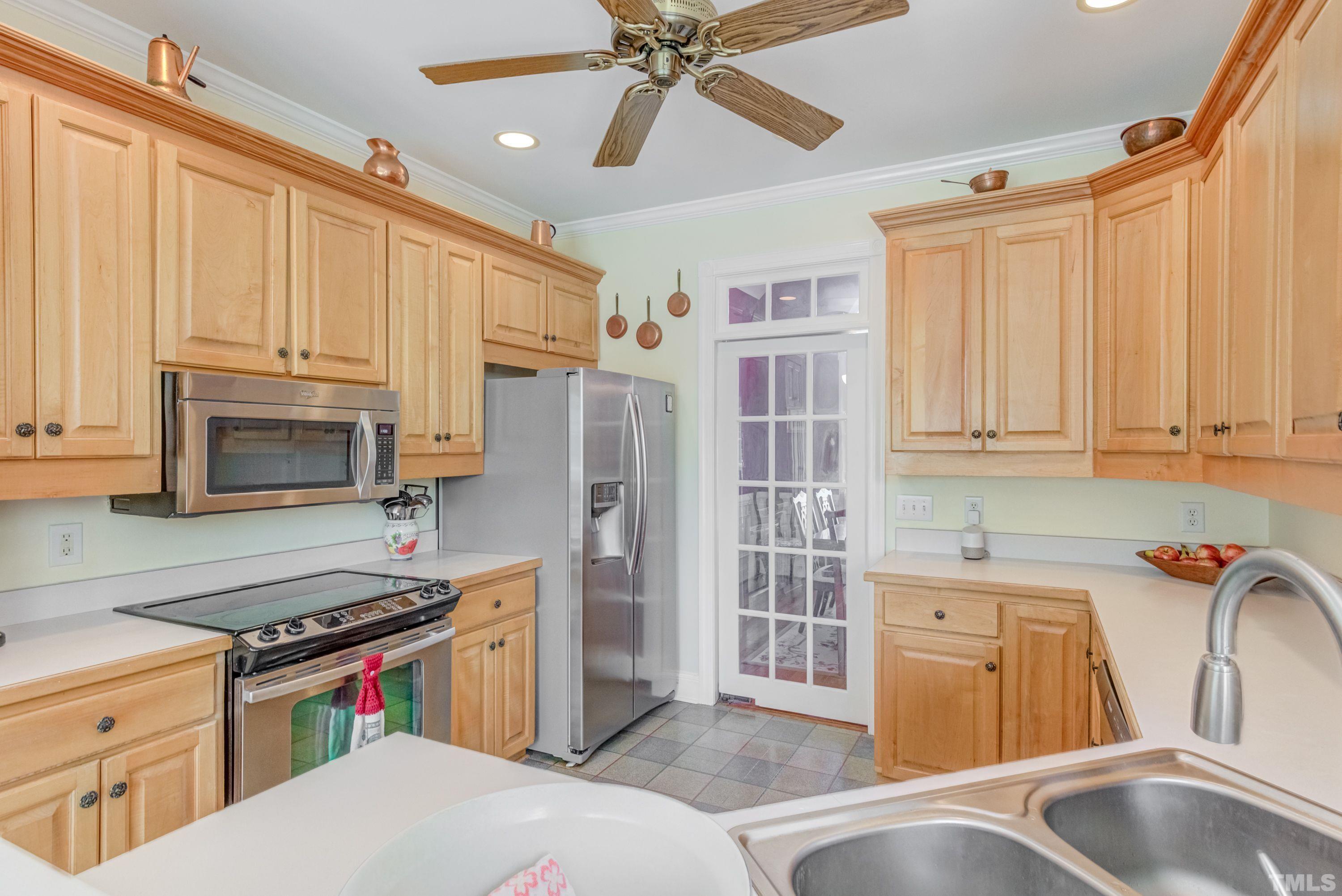 5646 Red Hill Church Road Coats, NC 27521 - Photo 24 of 31 a kitchen with stainless steel appliances granite countertop a sink stove and refrigerator