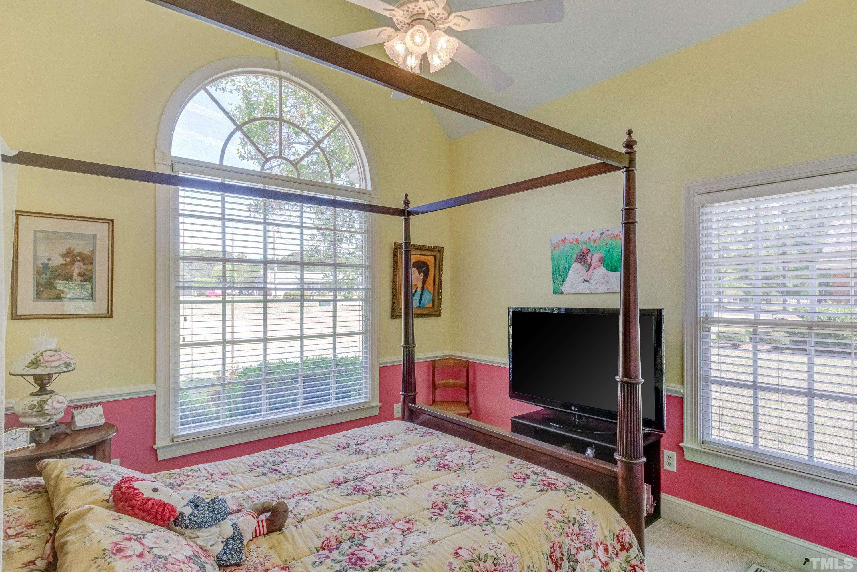 5646 Red Hill Church Road Coats, NC 27521 - Photo 5 of 31 a bedroom with a bed and a flat screen tv on the dresser
