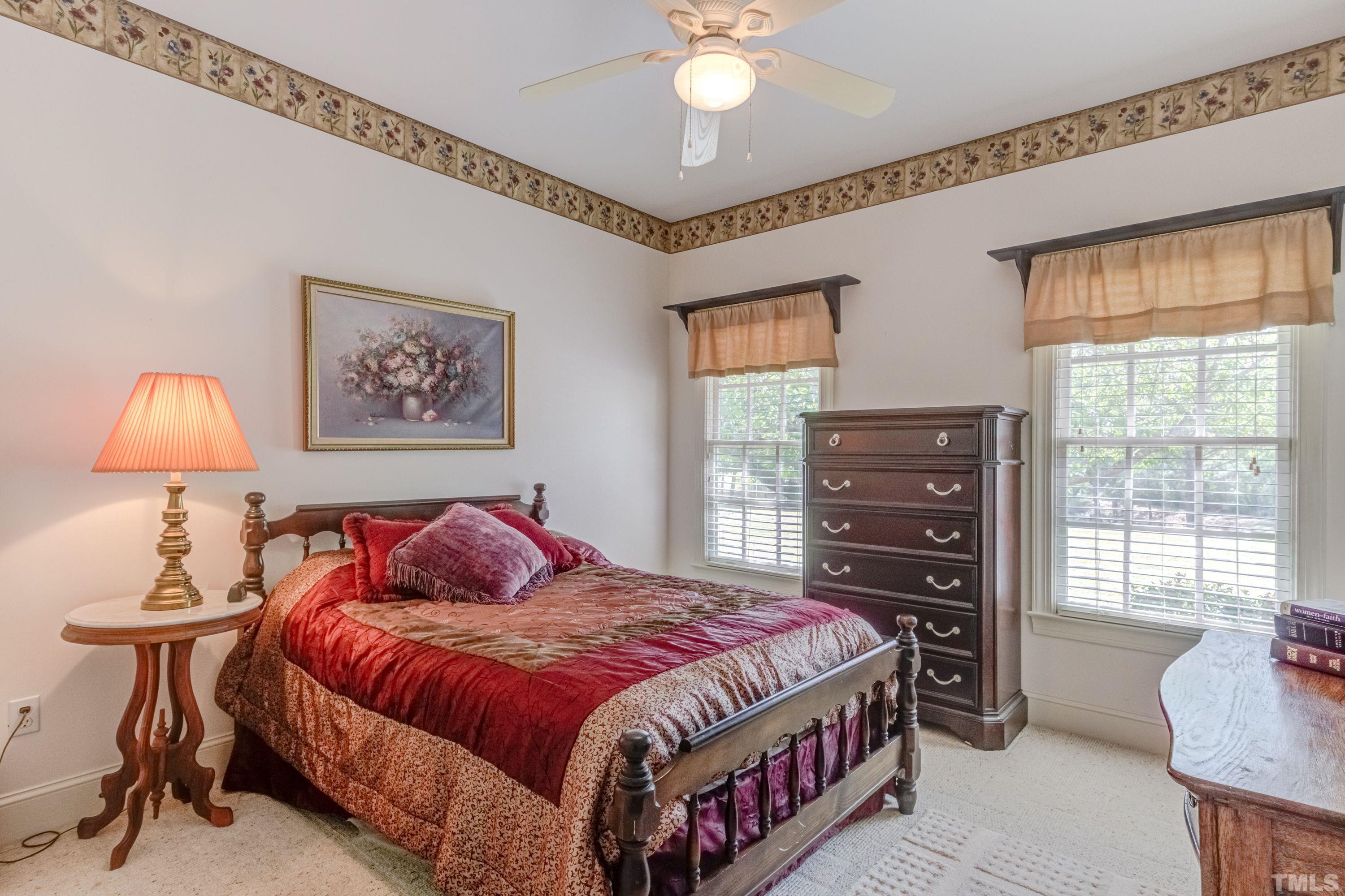5646 Red Hill Church Road Coats, NC 27521 - Photo 6 of 31 a bedroom with a bed and a chandelier
