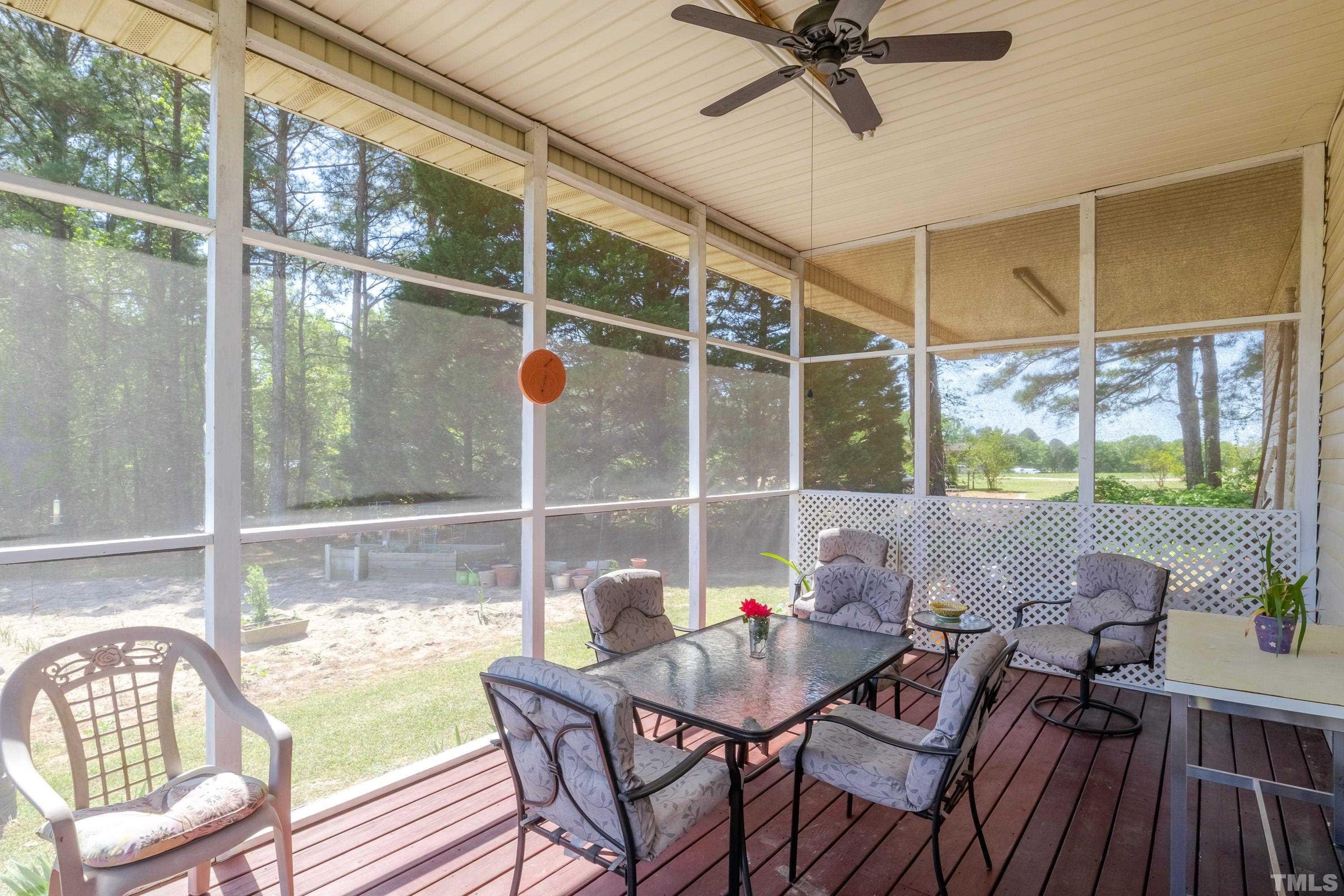 5646 Red Hill Church Road Coats, NC 27521 - Photo 7 of 31 a view of a porch with furniture and a yard