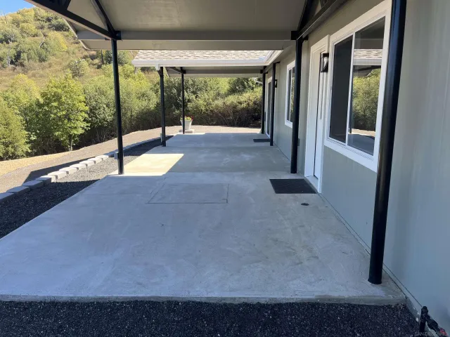 a view of a porch with a floor to ceiling window