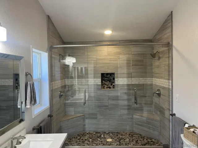 a bathroom with a shower and a sink
