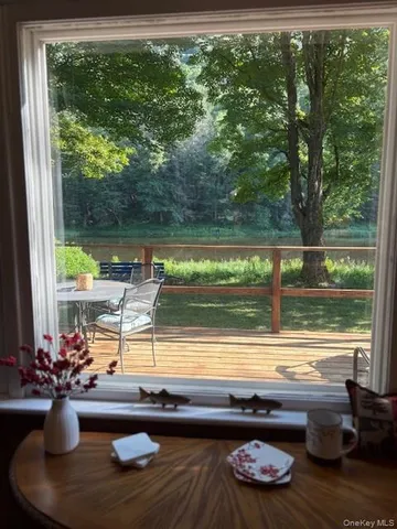 a living room with a couch a large window and a table