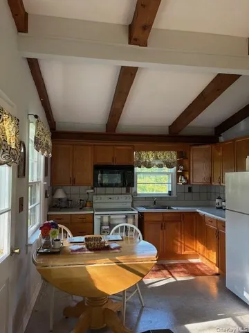 a kitchen with a sink cabinets and wooden floor