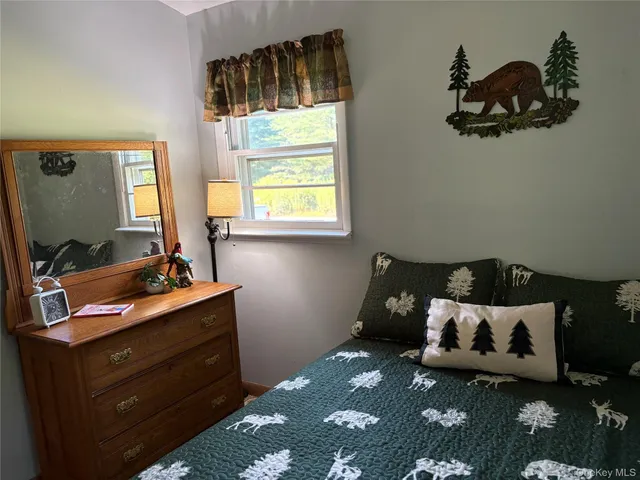 a bed sitting in a bedroom next to a window