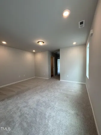 a view of an empty room and closet area
