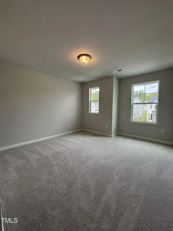 an empty room with windows and closet