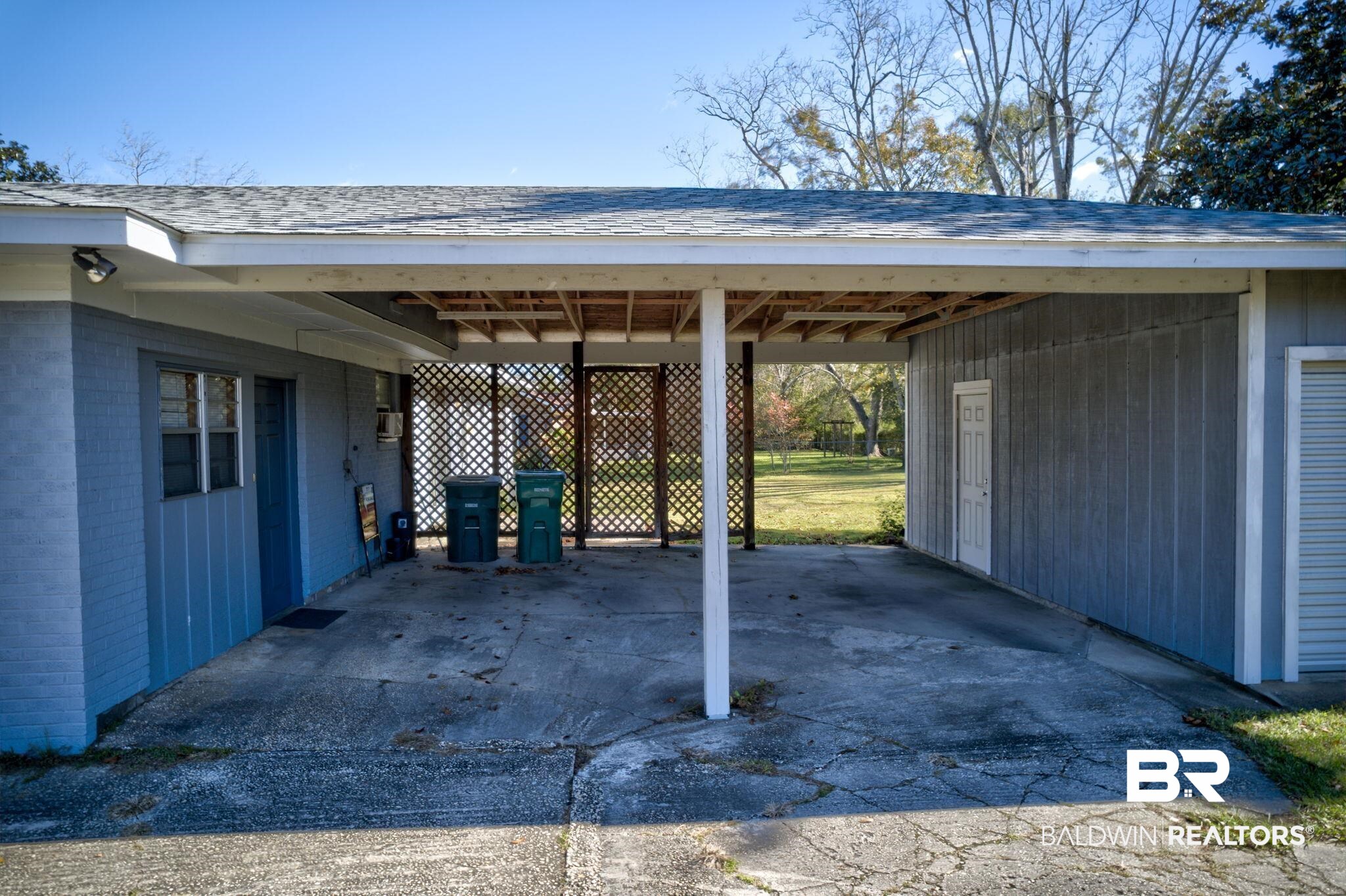 606 East Myrtle Avenue Foley, AL 36535 - Photo 11 of 24 View of parking featuring a carport