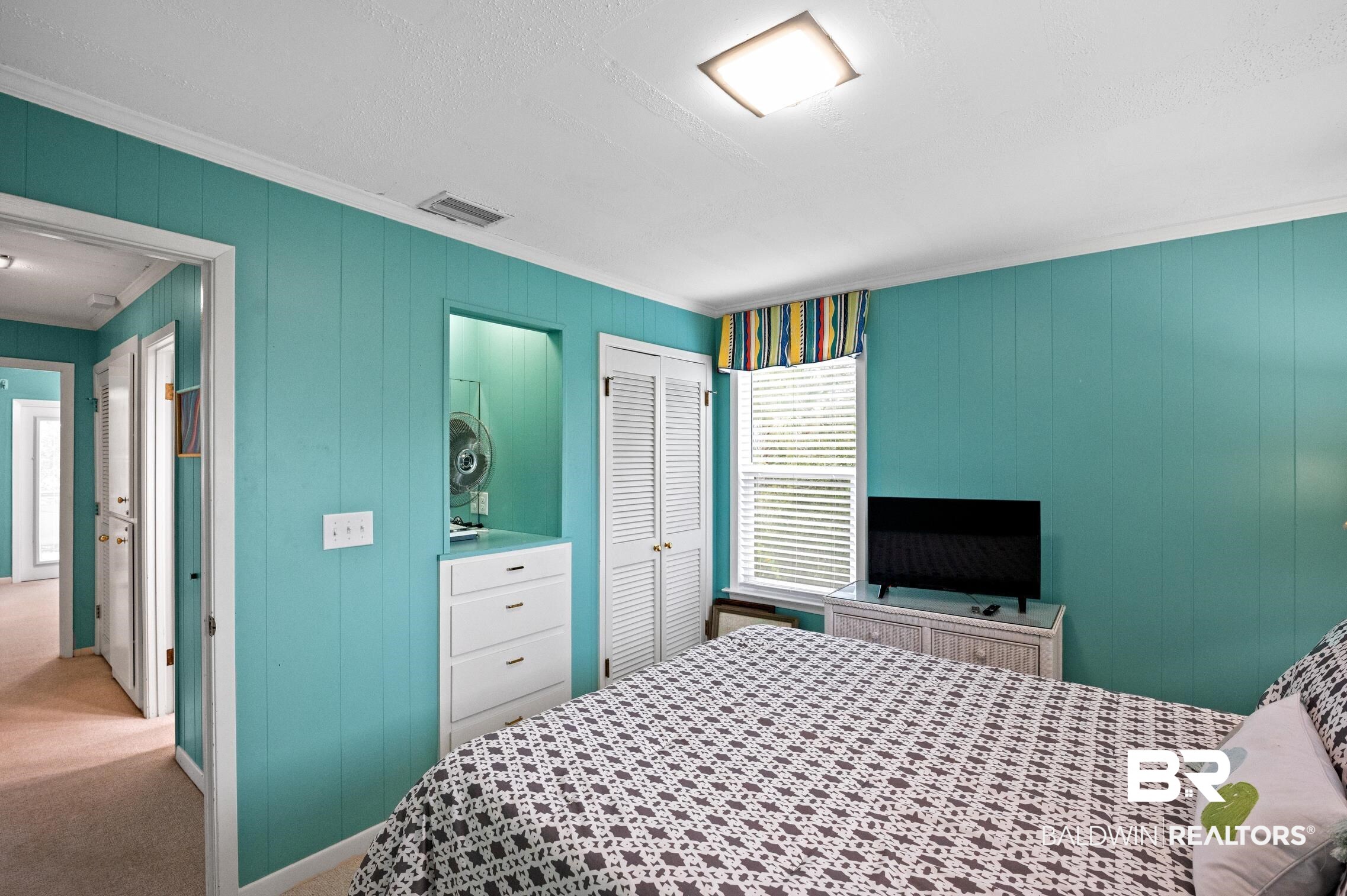 30388 River Road Orange Beach, AL 36561 - Photo 33 of 72 Bedroom with a closet, light carpet, crown molding, and visible vents