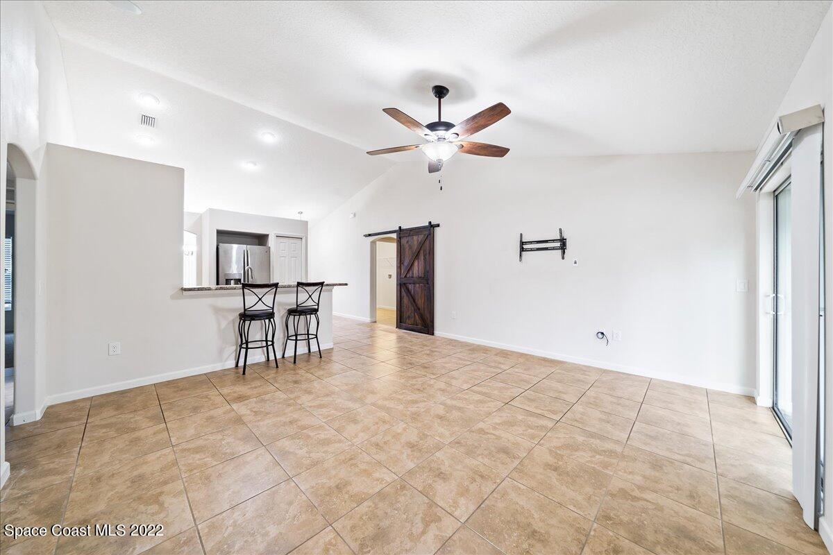 6175 Adina Road Cocoa, FL 32927 - Photo 13 of 29 a view of an empty room with furniture and a ceiling fan