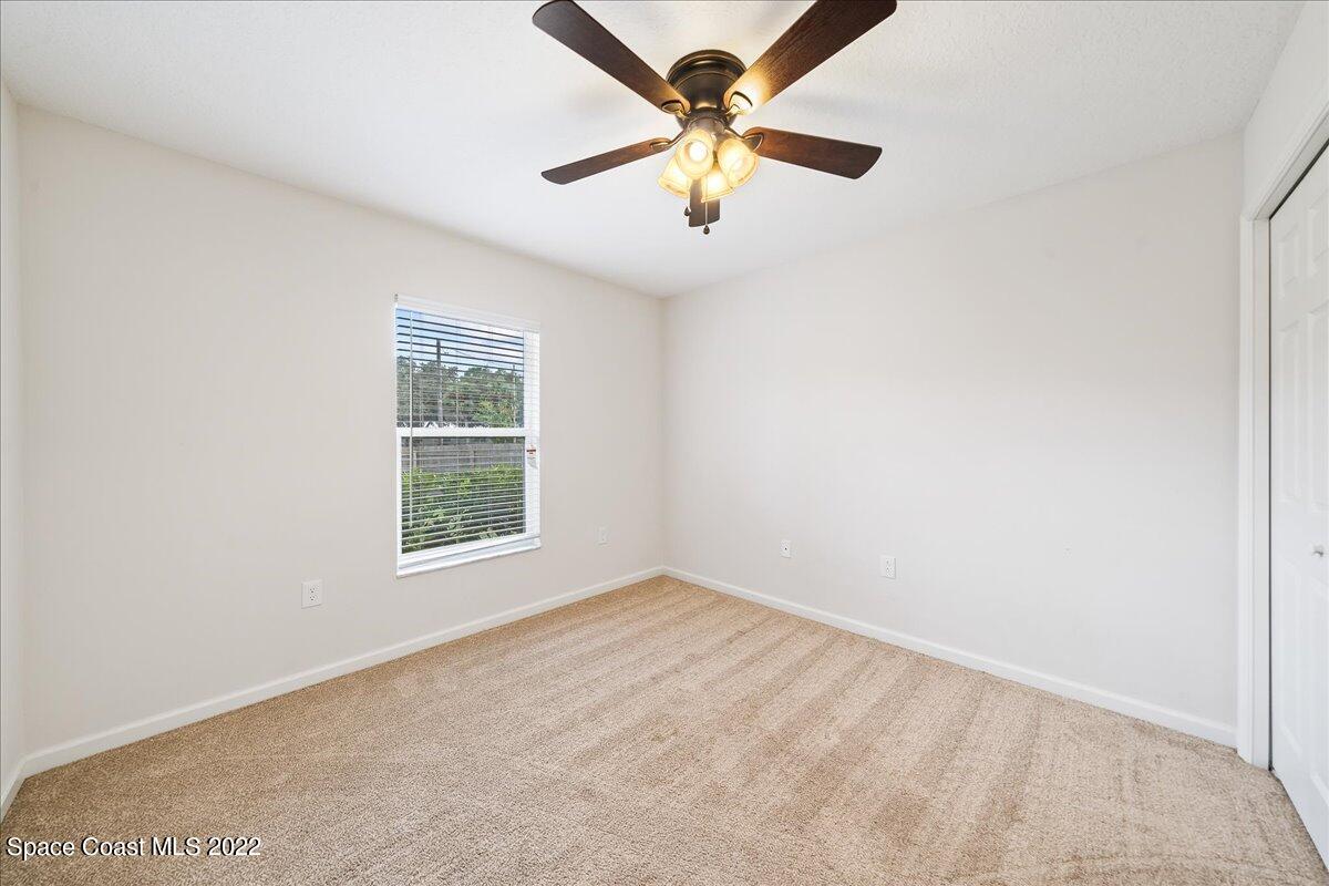 6175 Adina Road Cocoa, FL 32927 - Photo 16 of 29 an empty room with a window and a fan