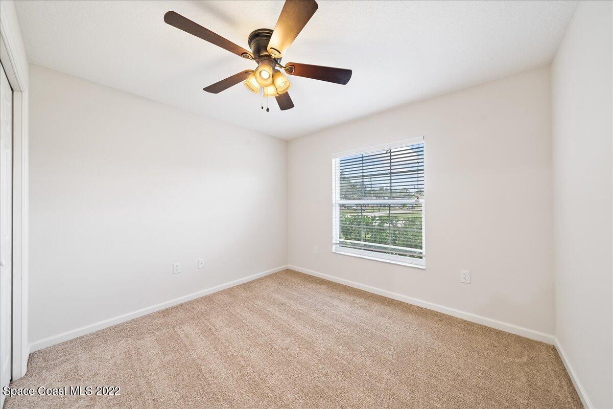 6175 Adina Road Cocoa, FL 32927 - Photo 17 of 29 an empty room with a window and a fan