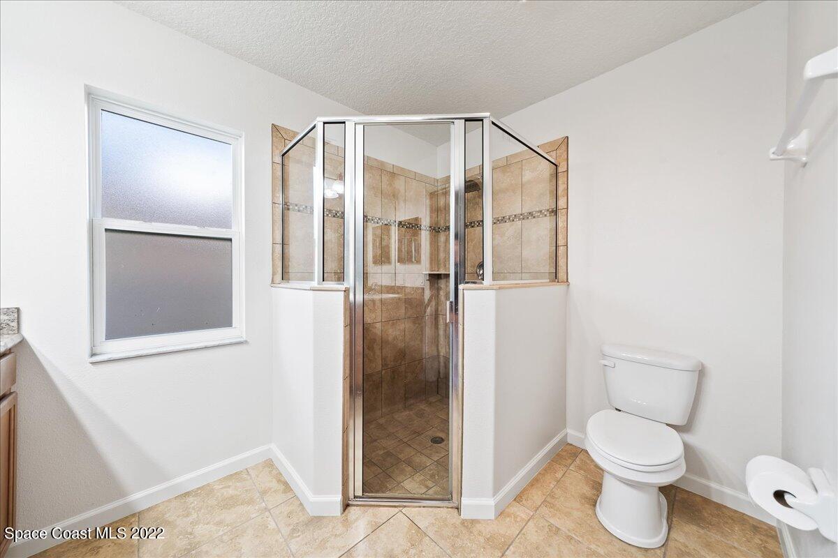 6175 Adina Road Cocoa, FL 32927 - Photo 24 of 29 a bathroom with a toilet and a shower