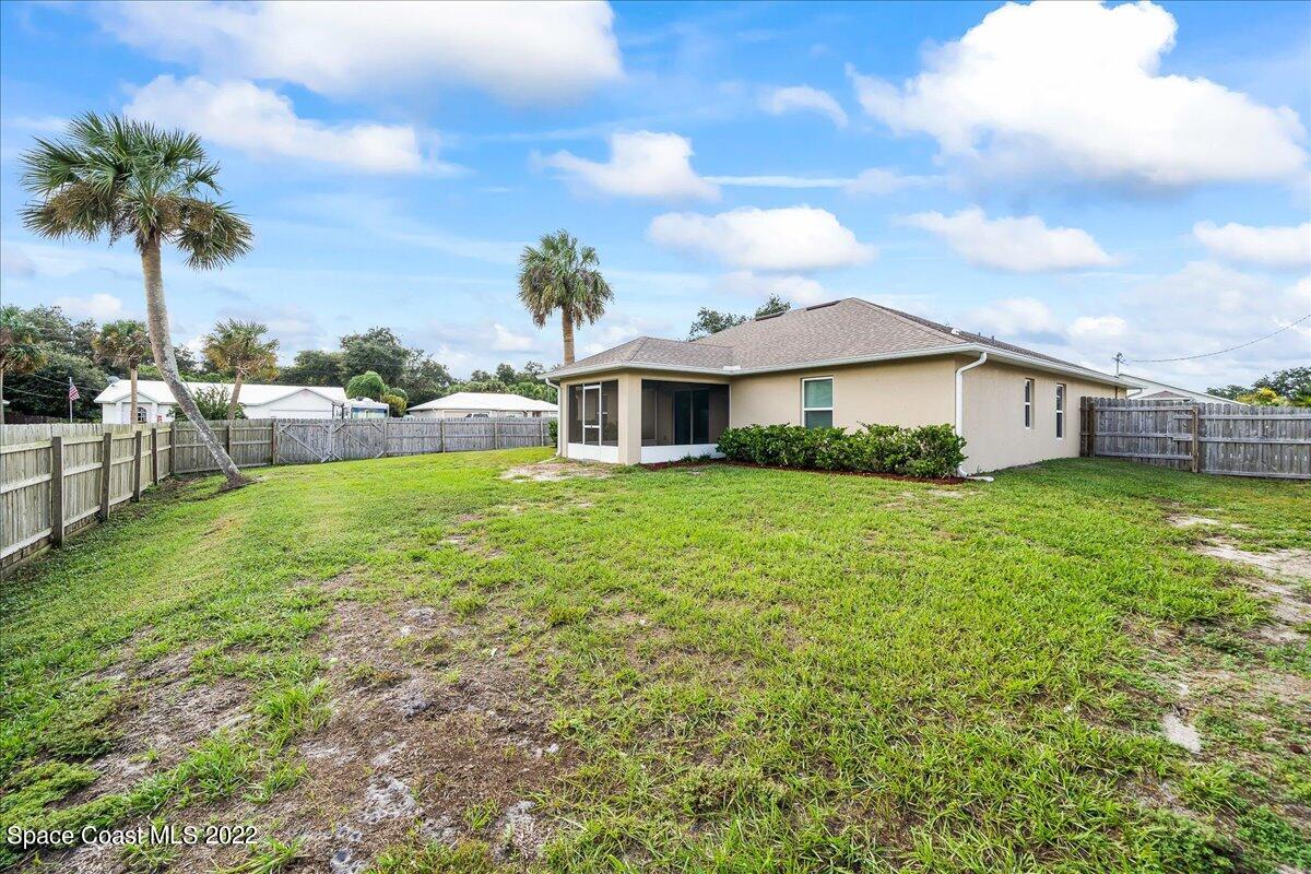 6175 Adina Road Cocoa, FL 32927 - Photo 29 of 29 a view of house with a big yard and potted plants
