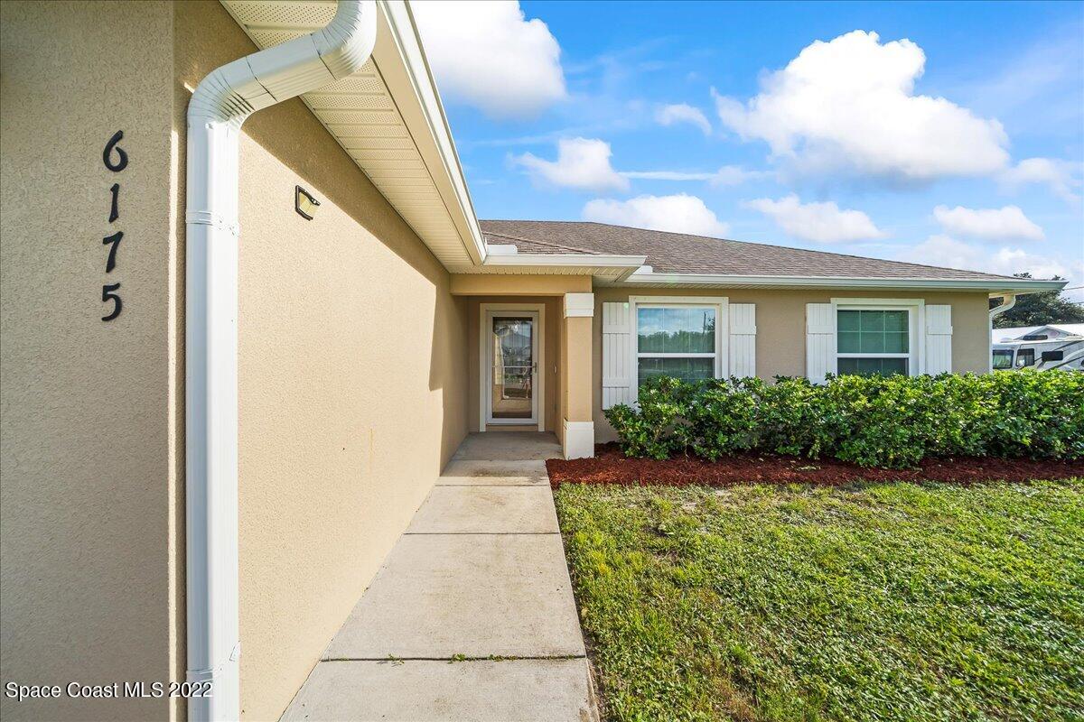 6175 Adina Road Cocoa, FL 32927 - Photo 3 of 29 a front view of a house with a yard