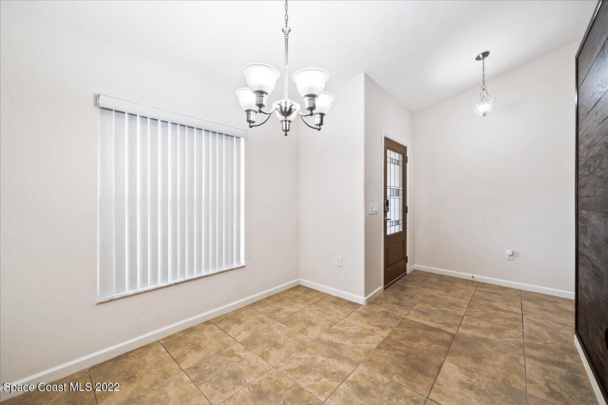 6175 Adina Road Cocoa, FL 32927 - Photo 5 of 29 a view of a livingroom with a chandelier fan and windows