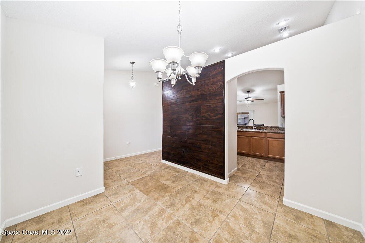 6175 Adina Road Cocoa, FL 32927 - Photo 6 of 29 a view of a kitchen with a sink and a chandelier