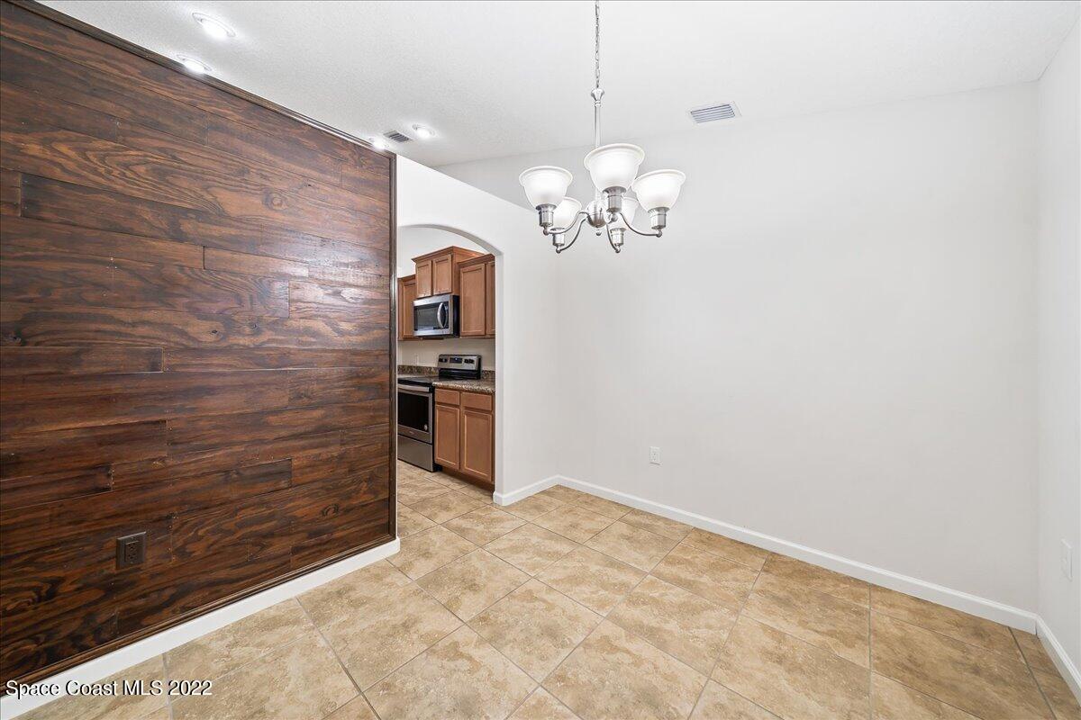 6175 Adina Road Cocoa, FL 32927 - Photo 7 of 29 a view of kitchen with refrigerator and microwave