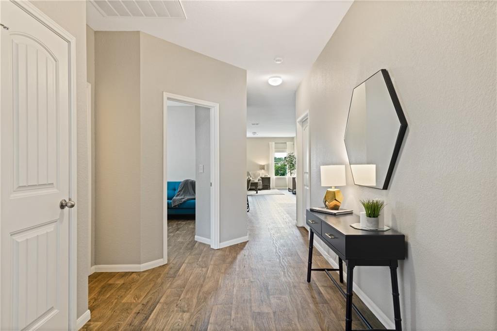 15117 Diamondleaf Cove Austin, TX 78724 - Photo 2 of 13 a living room with furniture and a mirror