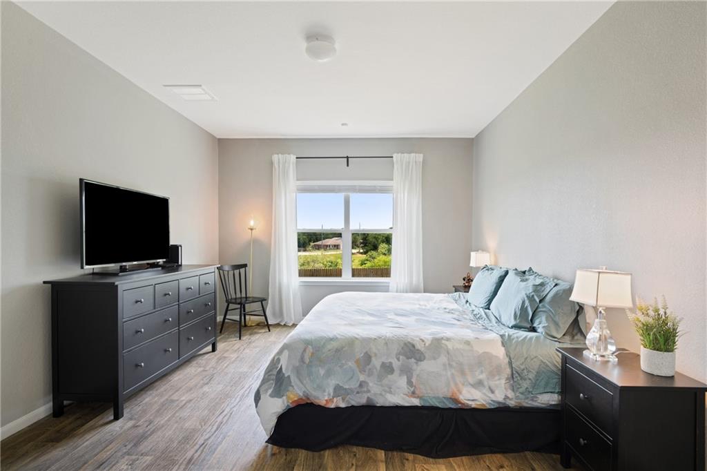 15117 Diamondleaf Cove Austin, TX 78724 - Photo 5 of 13 a bedroom with a bed and a flat screen tv