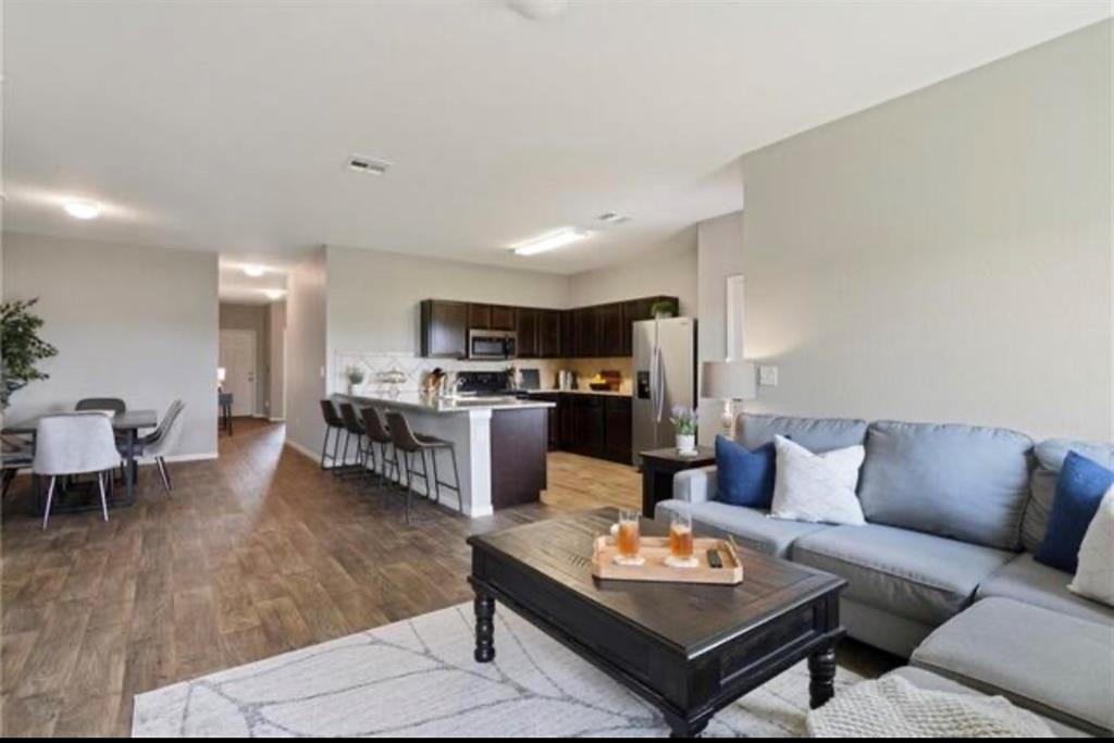 15117 Diamondleaf Cove Austin, TX 78724 - Photo 9 of 13 a living room with furniture kitchen view and a table