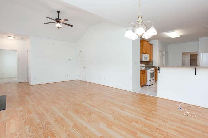 3402 Raes Creek Road, Unit 27 Marietta, GA 30008 - Photo 7 of 32 a view of a kitchen with a stove and a chandelier fan