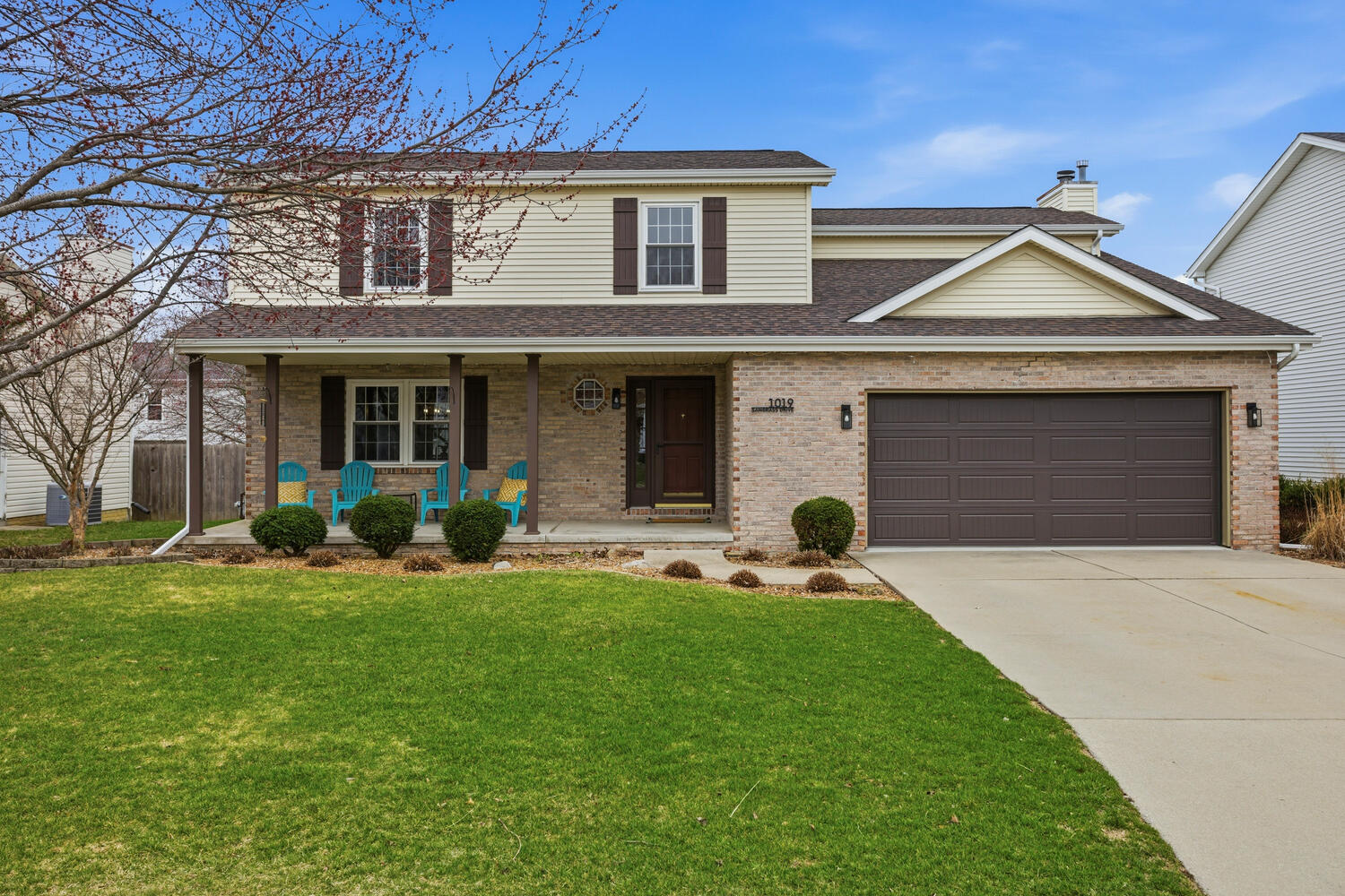 a front view of a house with a garden and yard