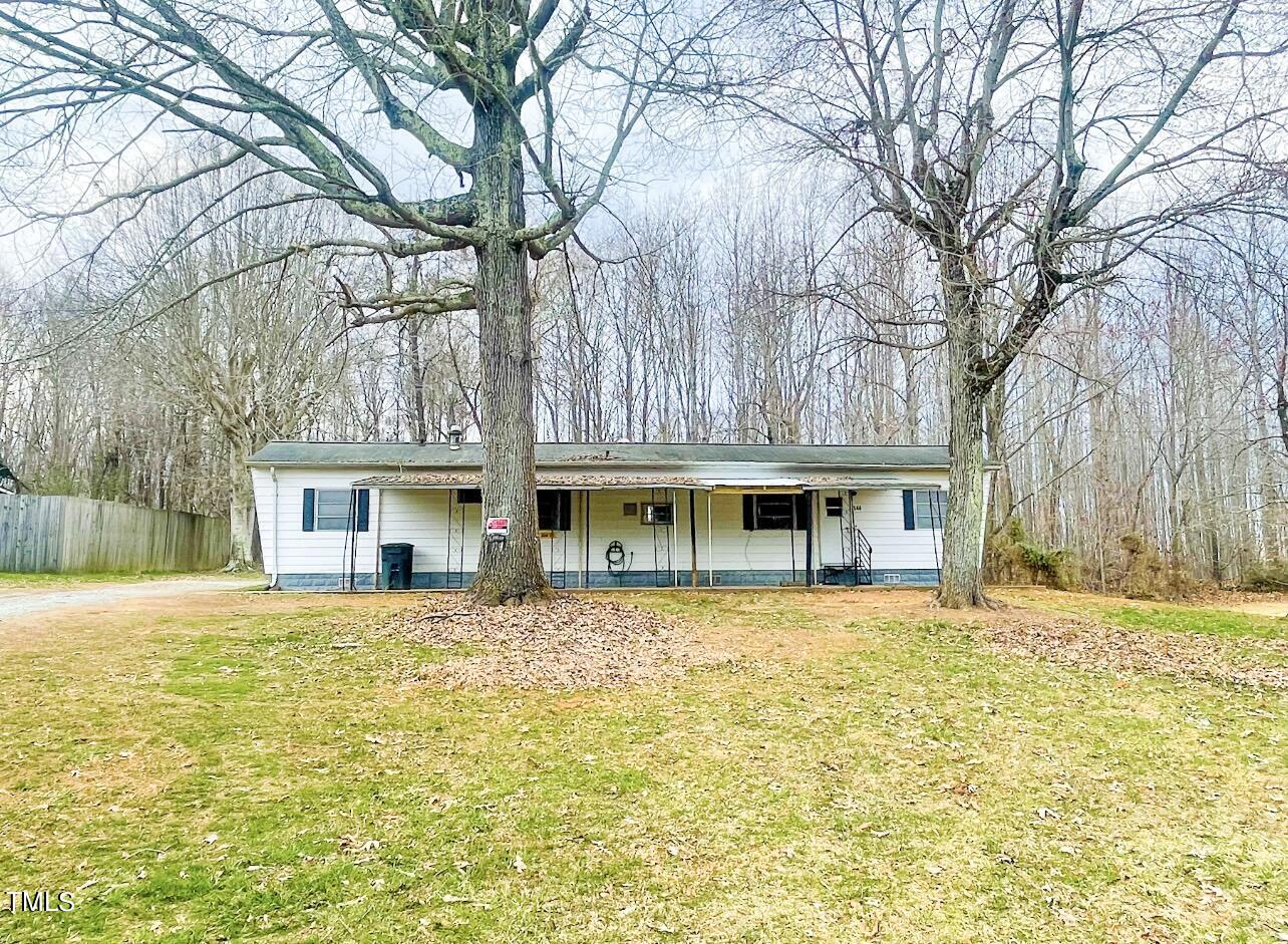 144 Henderson Road Roxboro, NC 27573 - Photo 1 of 11 a house that has a tree in front of it
