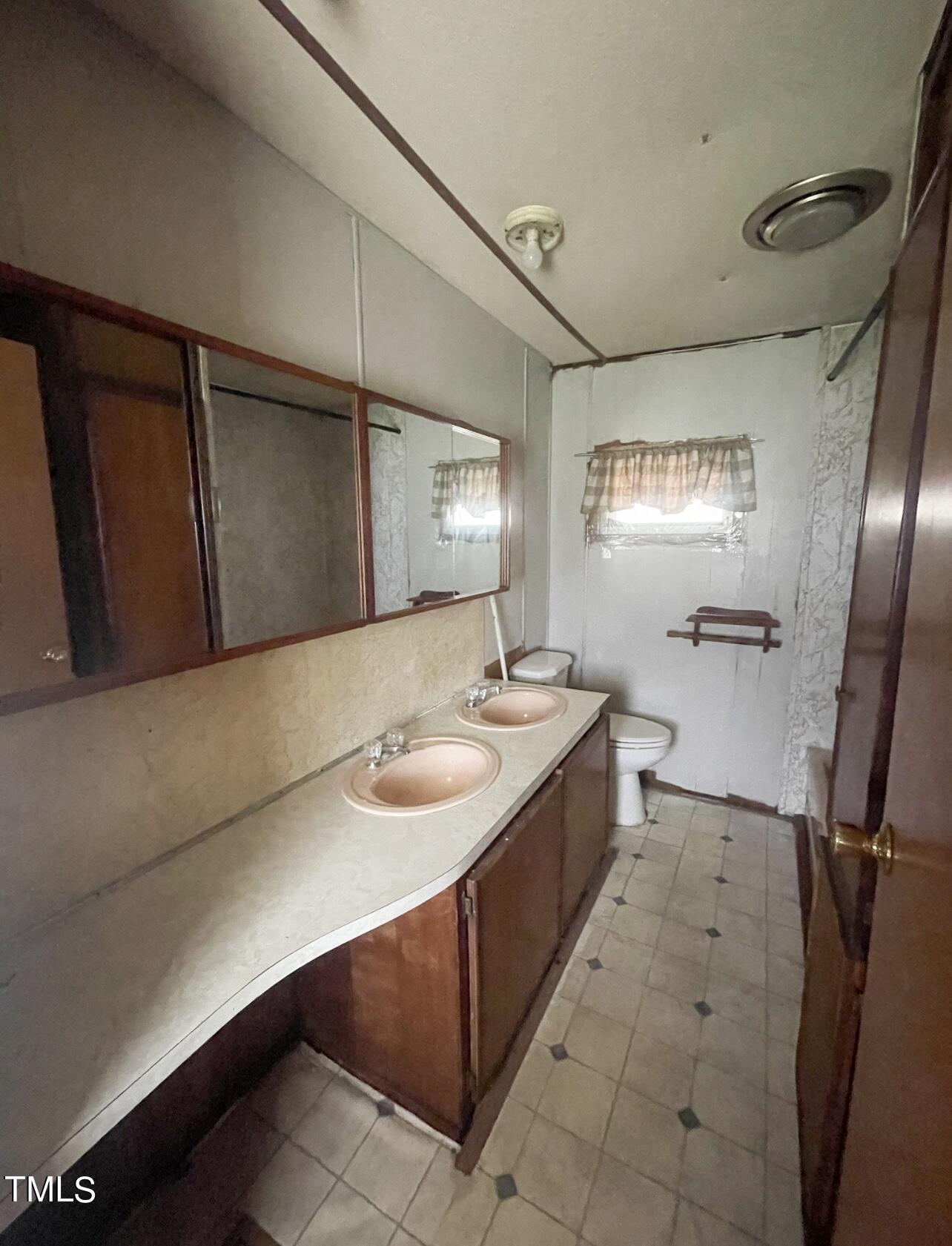 144 Henderson Road Roxboro, NC 27573 - Photo 8 of 11 a bathroom with a sink and mirror