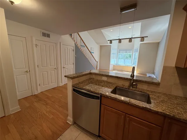 a kitchen with a sink and a mirror