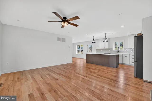 a view of a kitchen with wooden floor and a sink