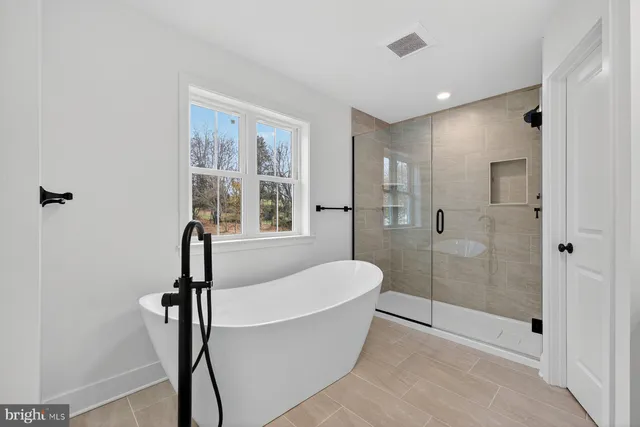 a bathroom with a bathtub and shower