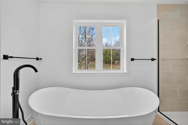 a white bath tub sitting next to a window