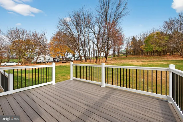 a view of deck with wooden floor and fence