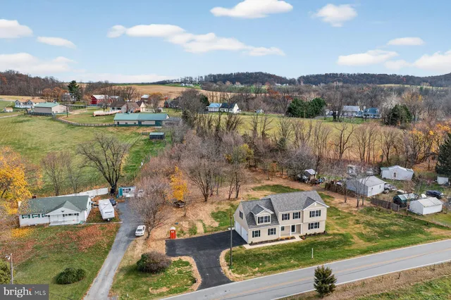 an aerial view of a house with a lake view