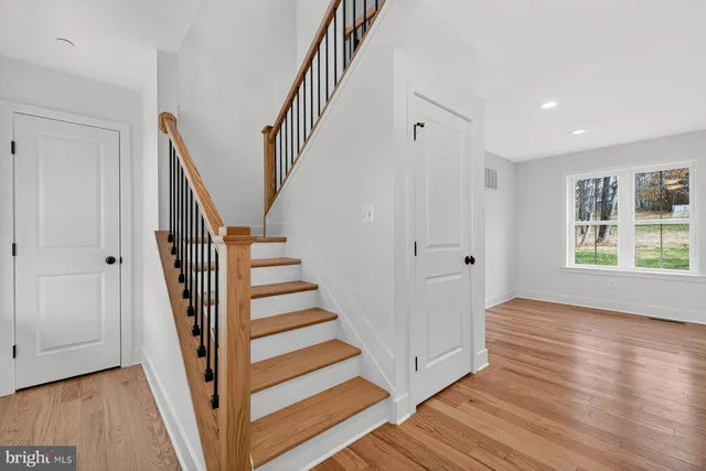 a view of entryway with wooden floor and stairs