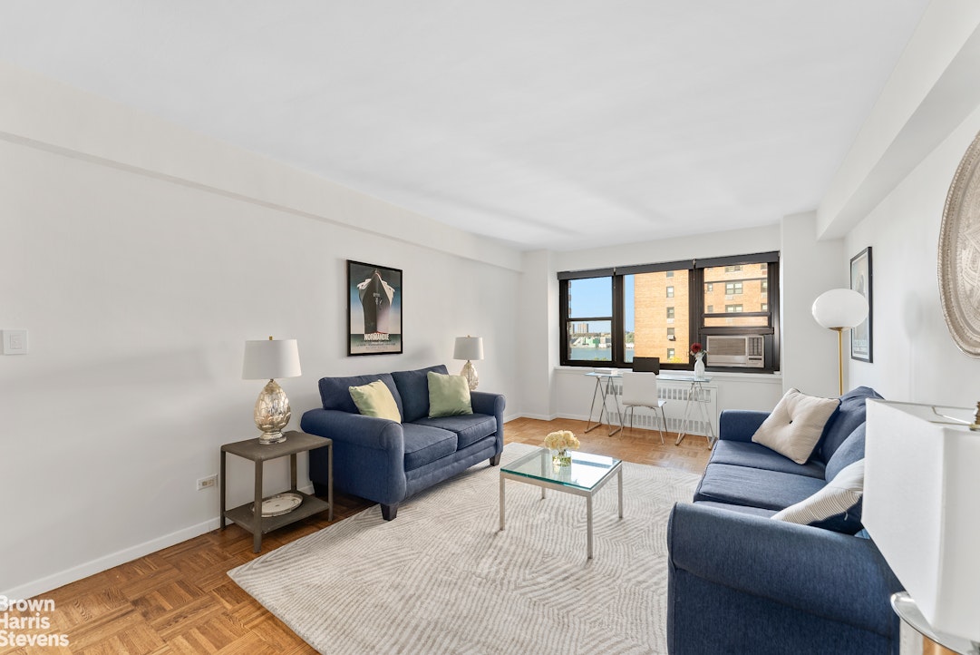 11 Riverside Drive, Unit 10PE Manhattan, NY 10023 - Photo 3 of 15 a living room with furniture and a wooden floor